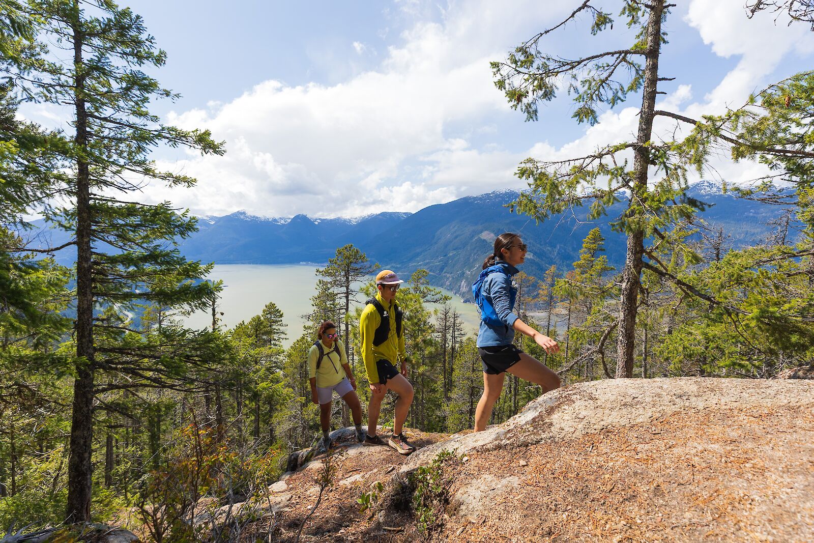 Friends hiking to the Summit of Sea to Sky Gondola with view of Howe Sound
