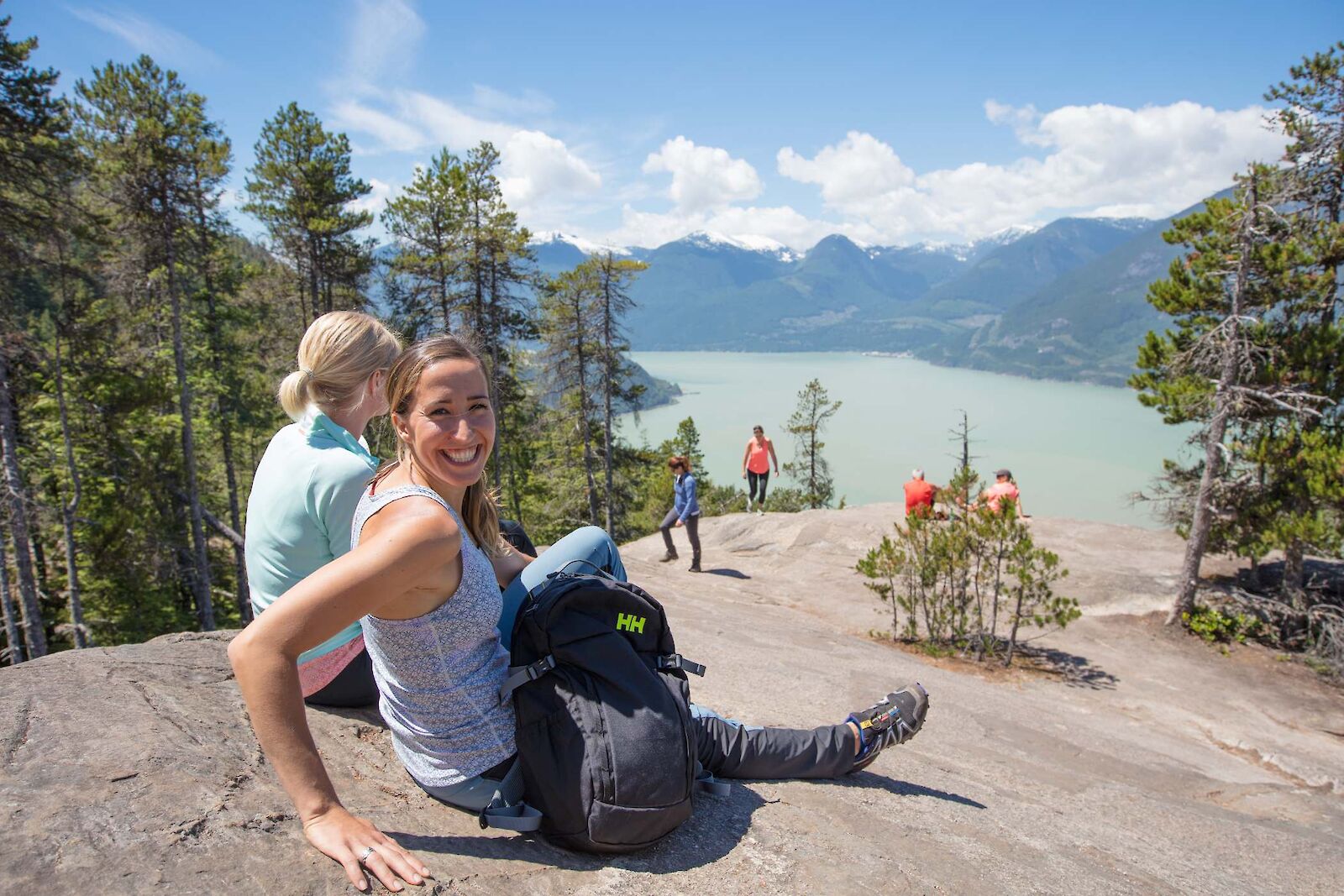 Two women relaxing after hiking with Howe Sound view in background