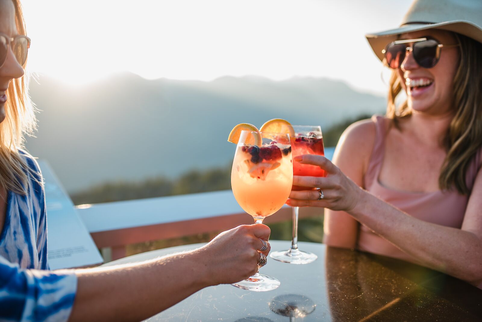 Two women enjoying drinks on the Summit Lodge patio