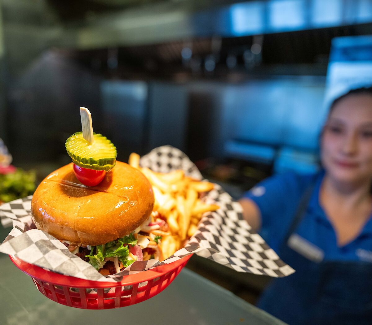 Staff member serving Korean BBQ sandwich at the Sky Pilot Smokehouse