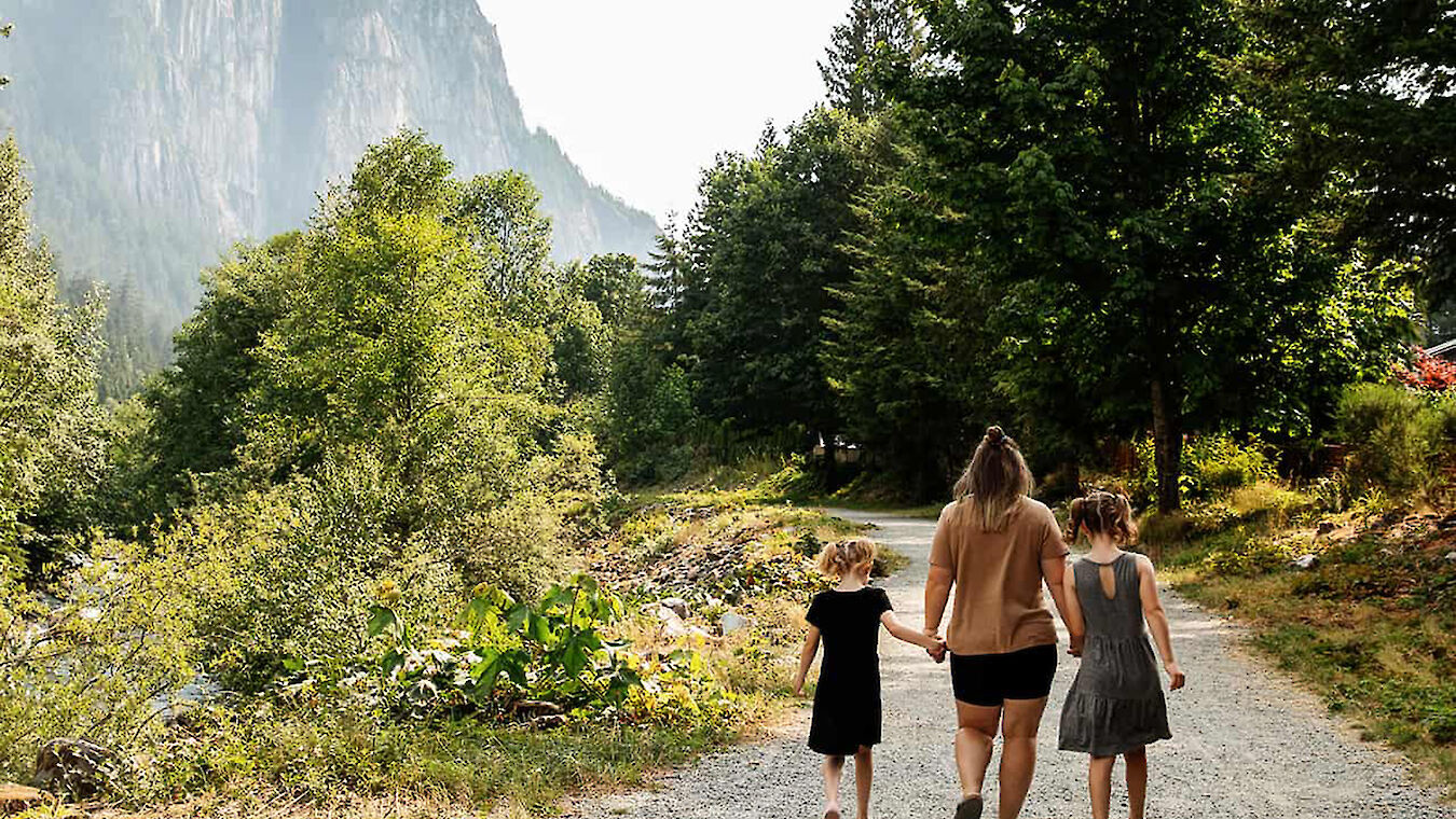 family on path beside Squamish Chief