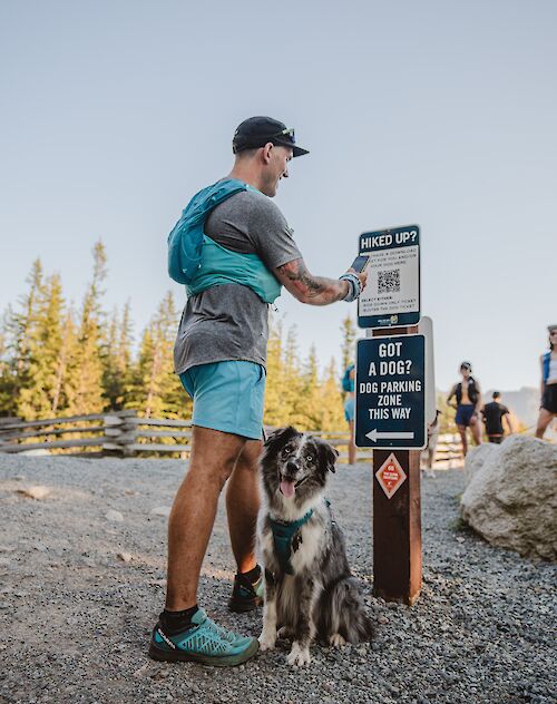 A man on the trail with his dog