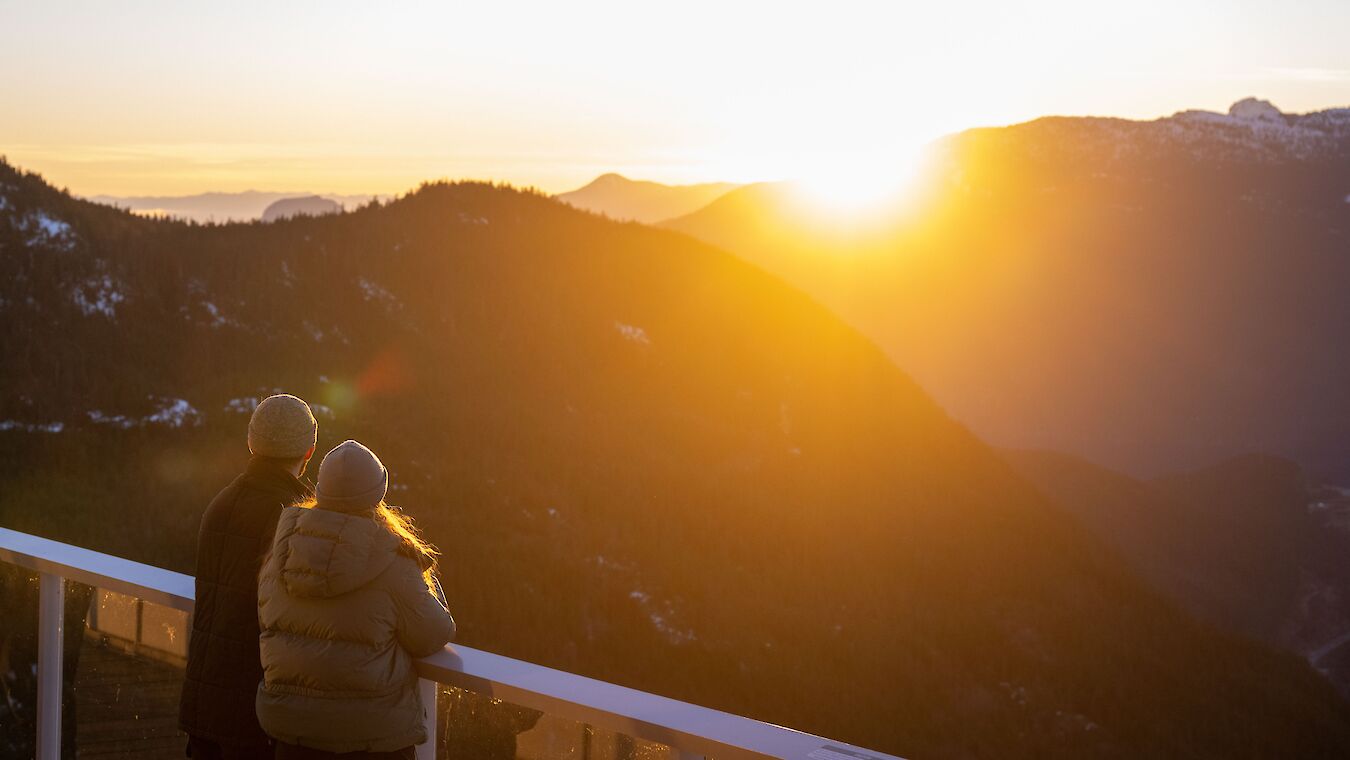 a couple looking at the view and sunset