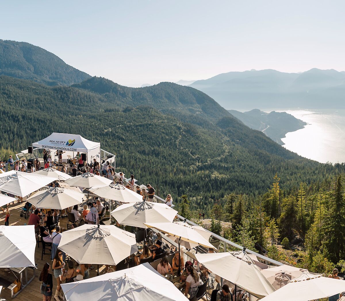A deck filled with people overlooking the howesound