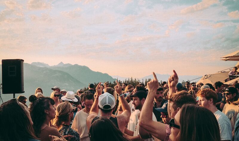 a group of people enjoying music at sunset