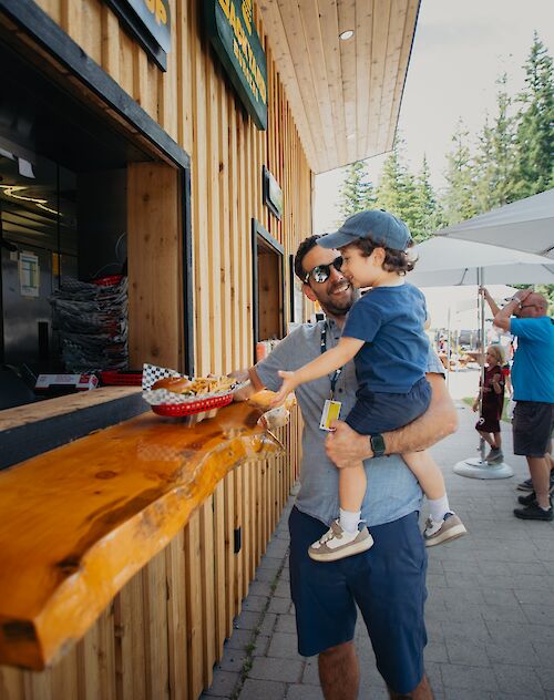 a father and son grabbing a burger