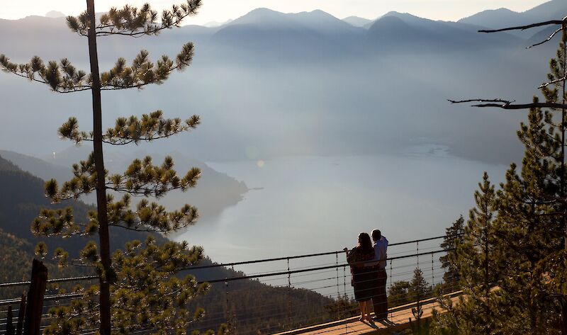 a couple on the suspension bridge looking at the view