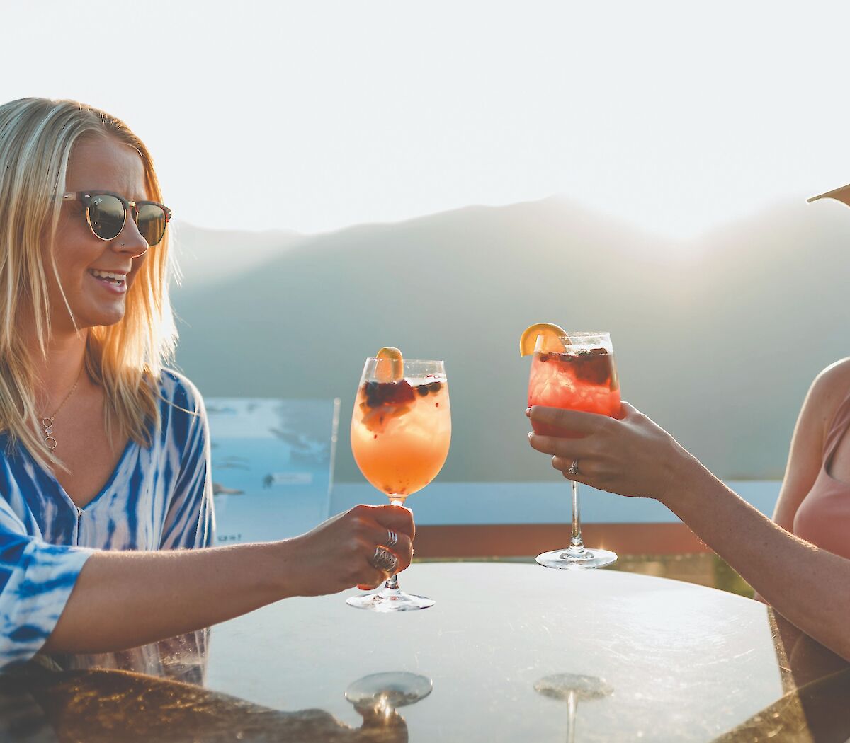 two friends enjoying drinks on the patio