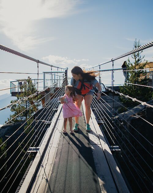 a mother and daughter on the suspension bridge