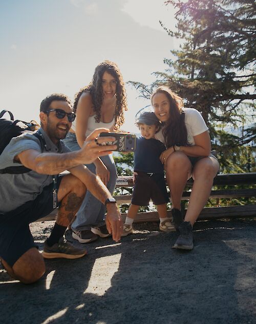 a family taking a photo together on the trail