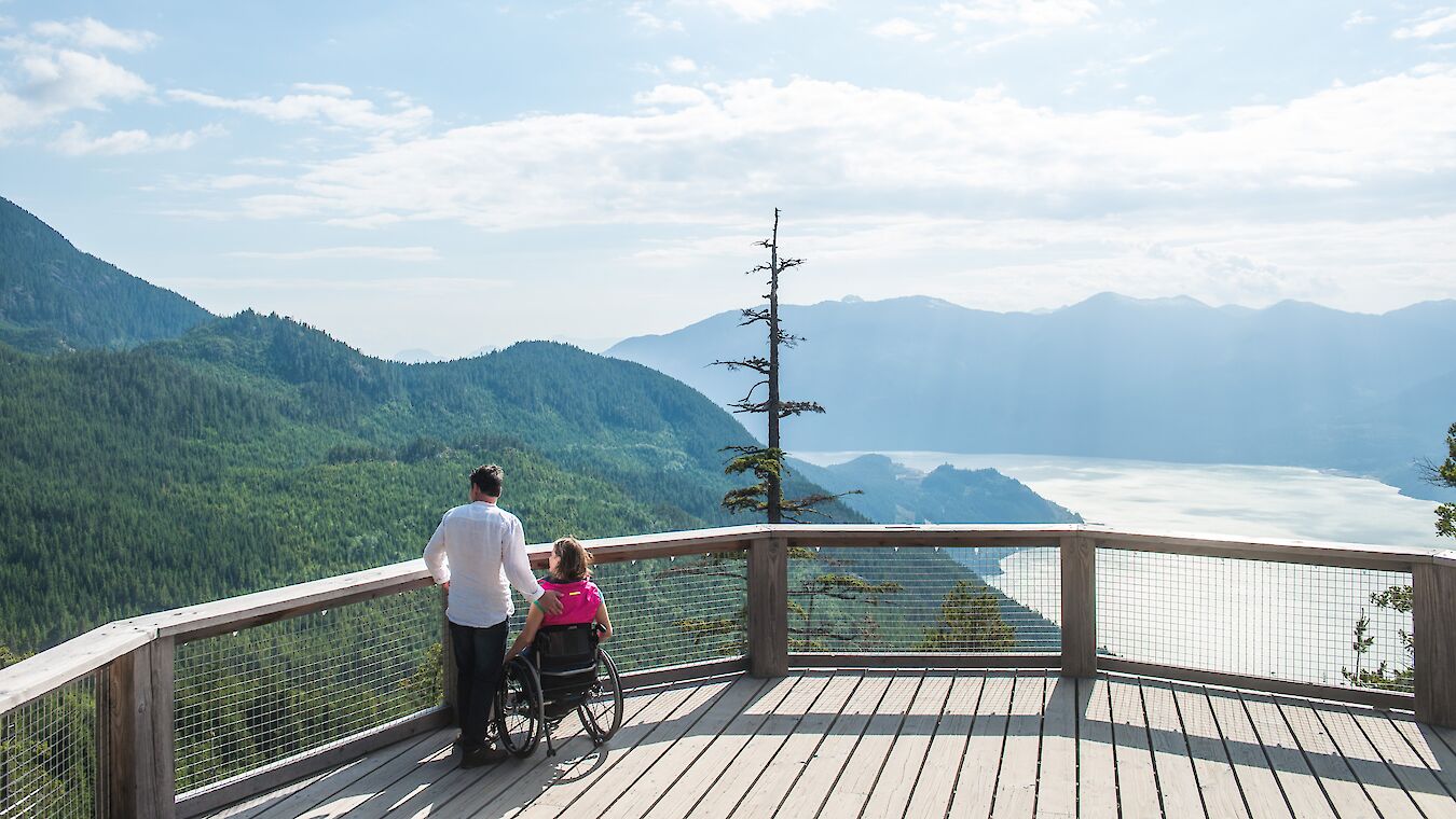 a man and women in a wheelchair on the spirit viewing deck