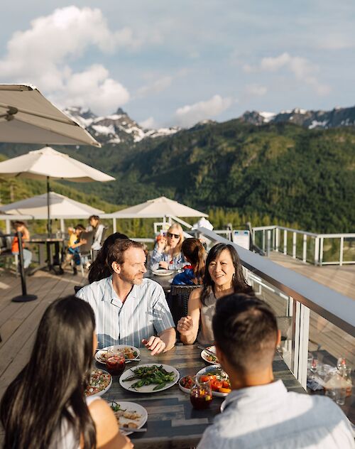 two couples sharing a meal at Taste of the Summit