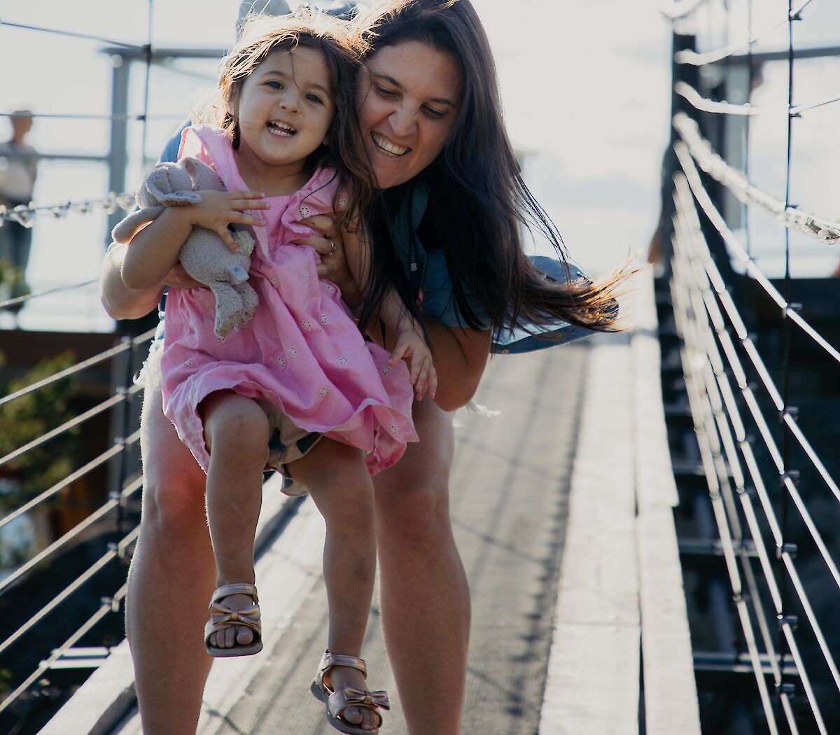 a mom and daughter on the suspension bridge