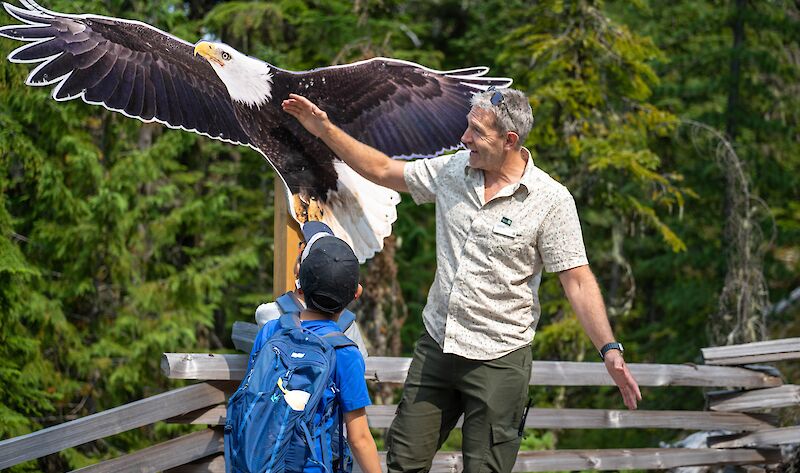 Arron showing talking about eagles with a young boy