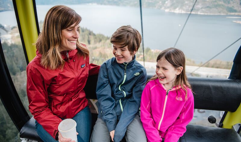 a family riding up the gondola