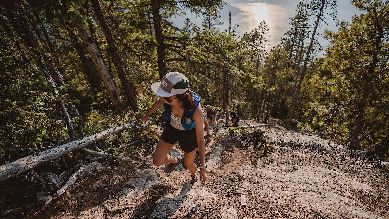 a girl hiking up a trail