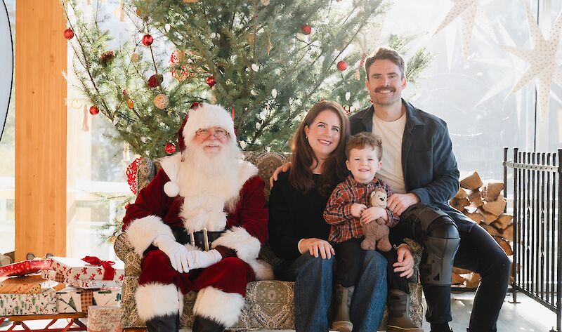 a family taking a photo with Santa at the summit
