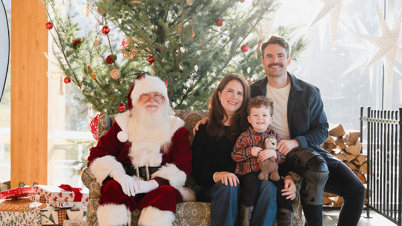 A family posing for a picture with Santa
