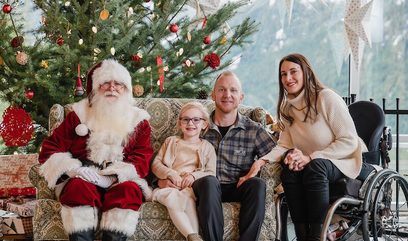 A family posing for a picture with Santa